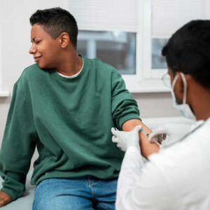 Teenager receiving a vaccination from a healthcare provider ahead of school resumption in Nigeria
